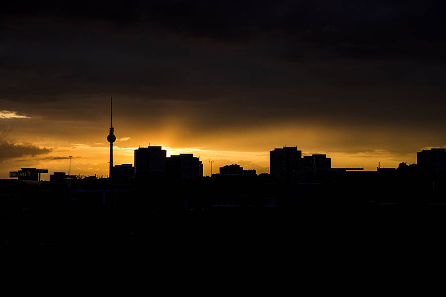 Berlin’s skyline with buildings and the TV Tower silhouetted at sunset