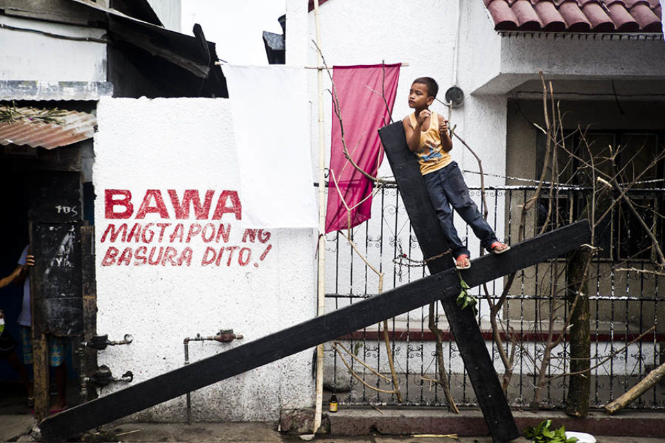 Boy standing on crucifix to watch the processions