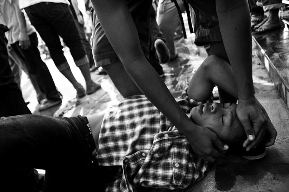 A celebrant has help during the festival