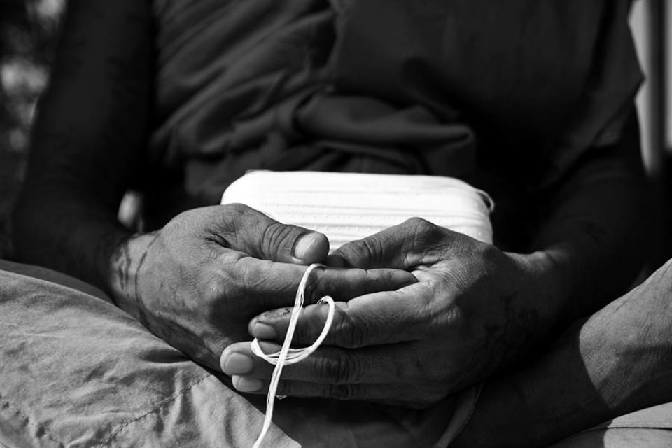 Monk praying with sacred string