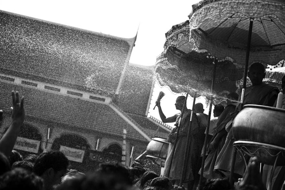 Monks bless the festival crowd with water