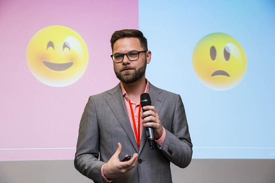 Speaker at corporate event with emoticons