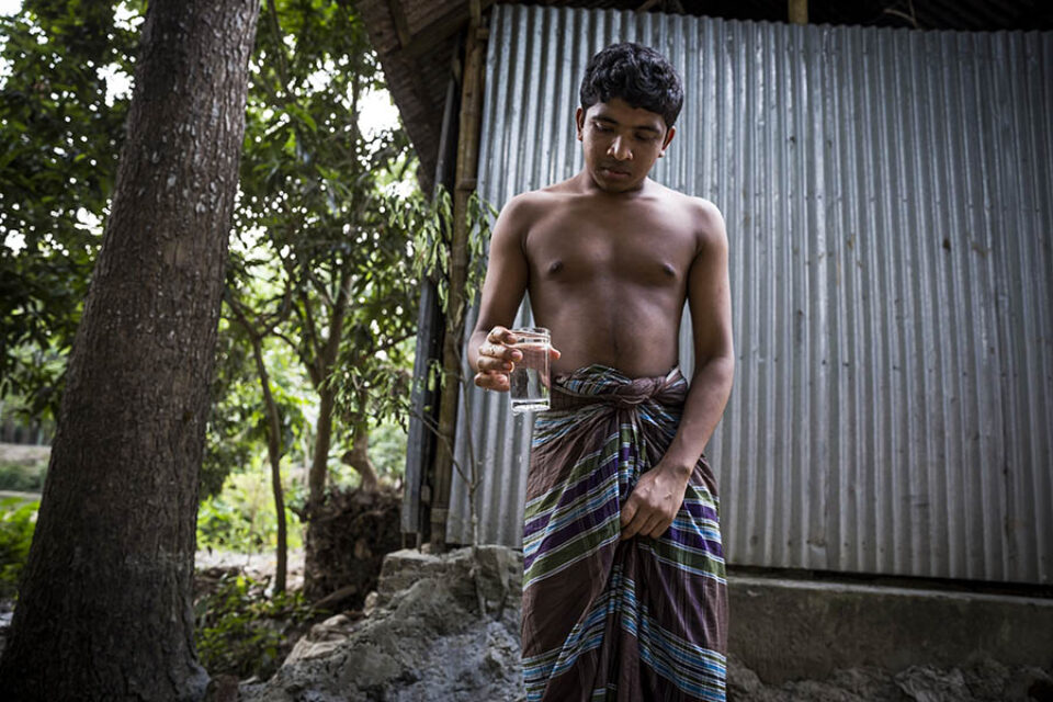 Young man with glass of water