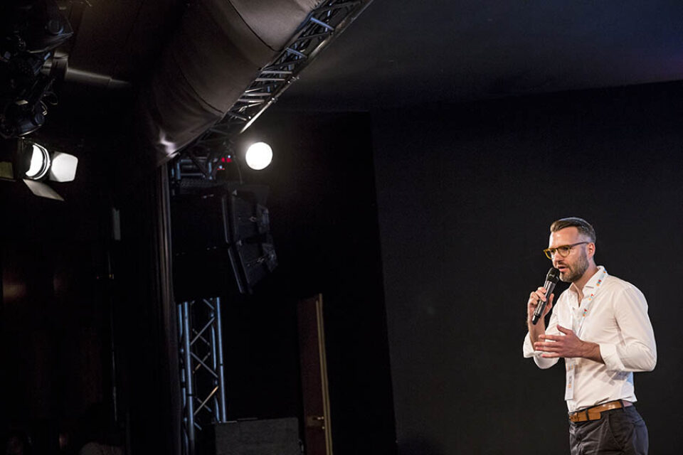 Man giving presentation onstage at event