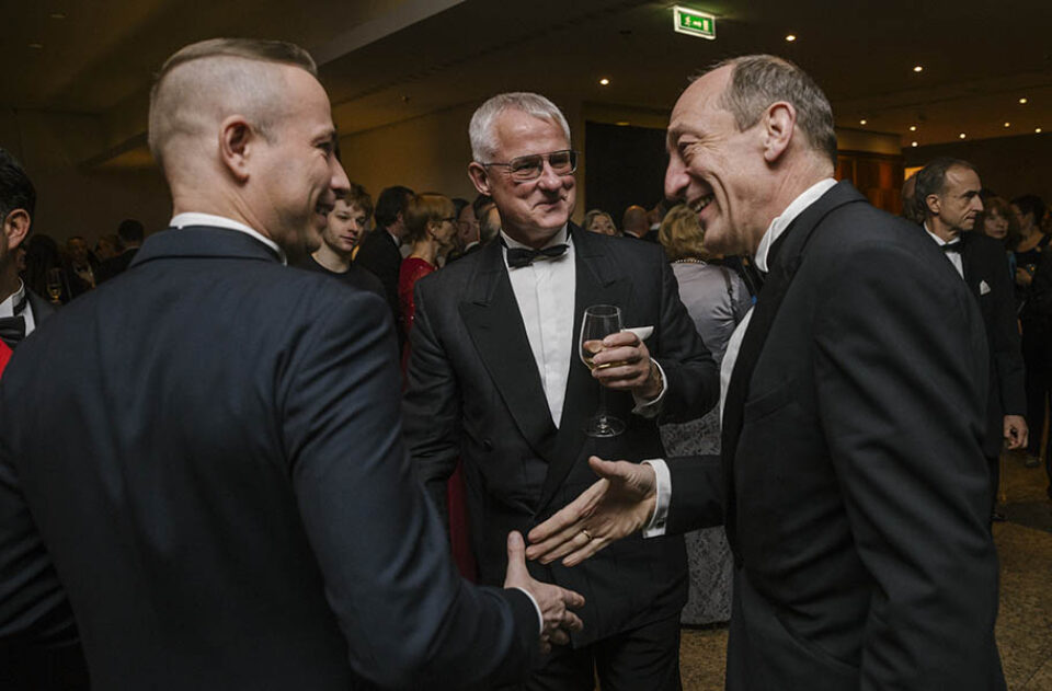 Gala dinner guests about to shake hands