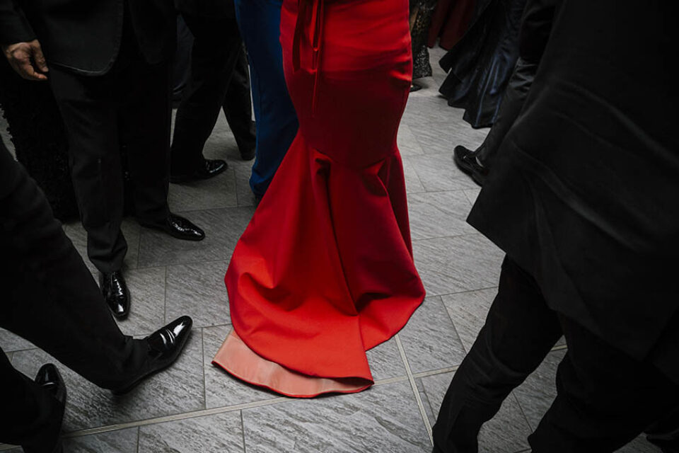 Red ballgown among black clothing