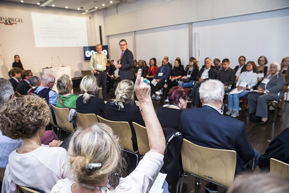 Woman raising hand at event