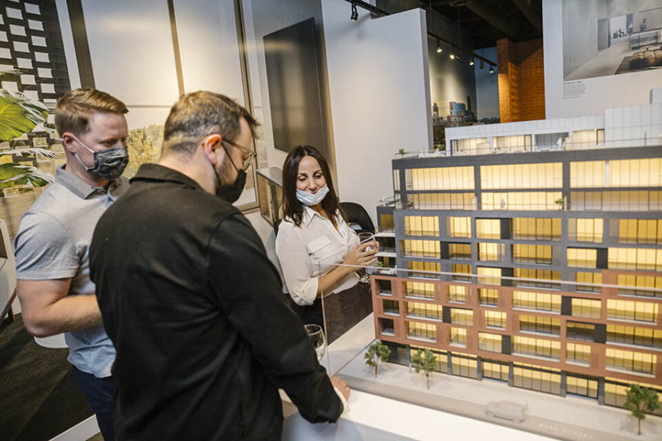 Clients inspecting scale model, Ottawa condo development