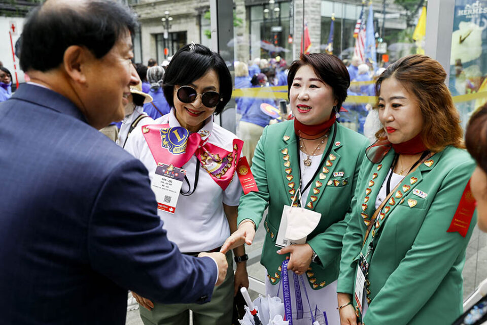 Delegates greet each other at Montreal street parade