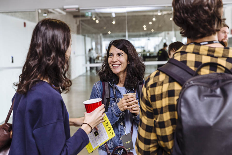 Attendees chat at corporate tech event