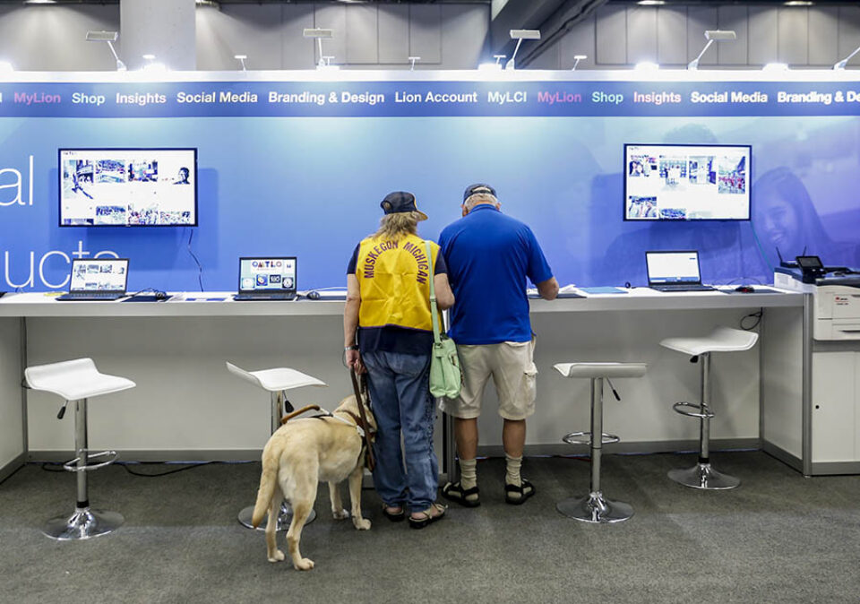 Visually impaired convention delegate with guide dog