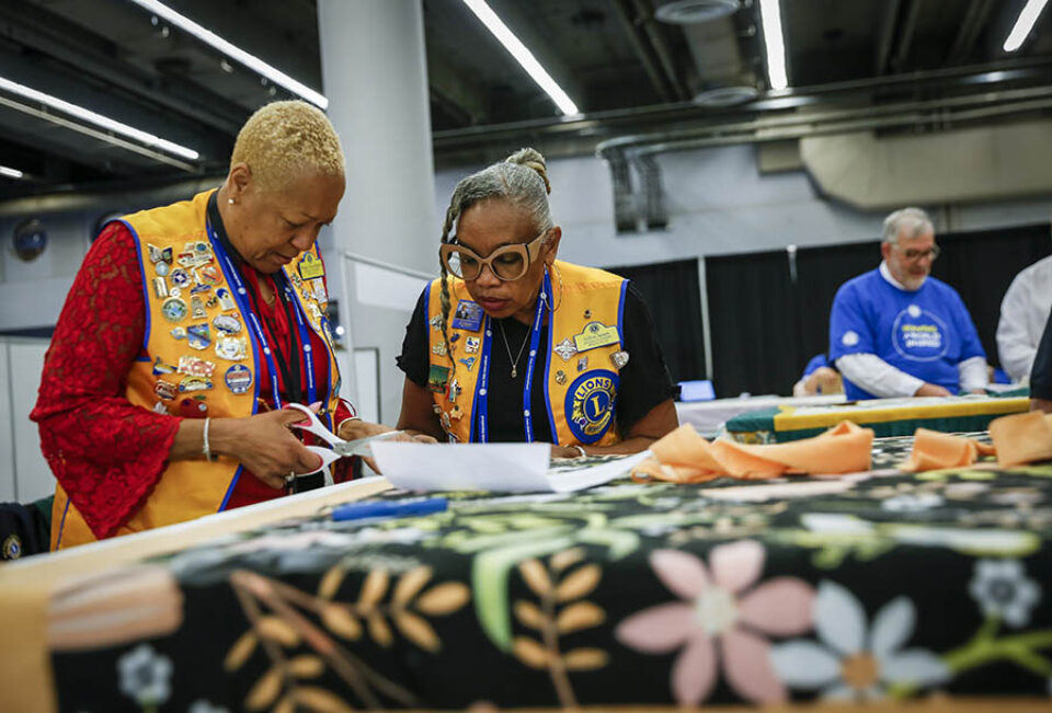 Workshop attendees make a blanket