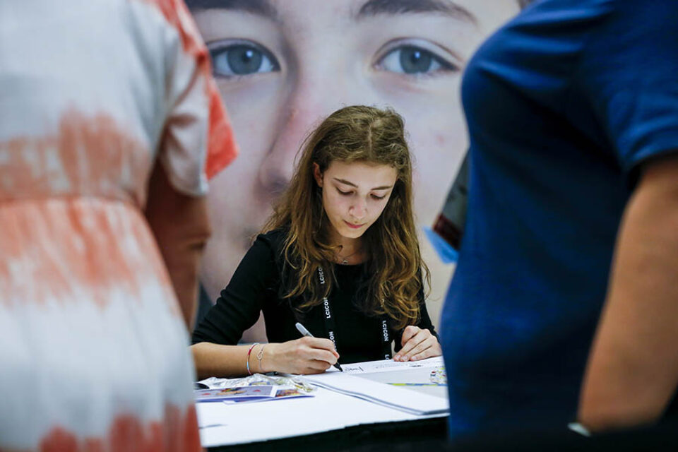 Young artist autographing her artwork