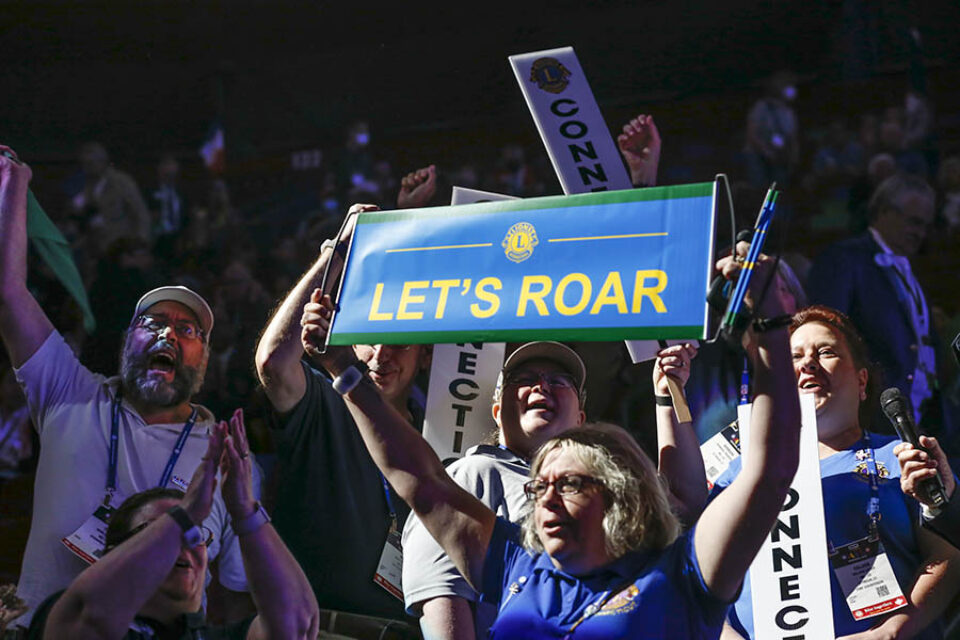 Delegates wave placards with slogans