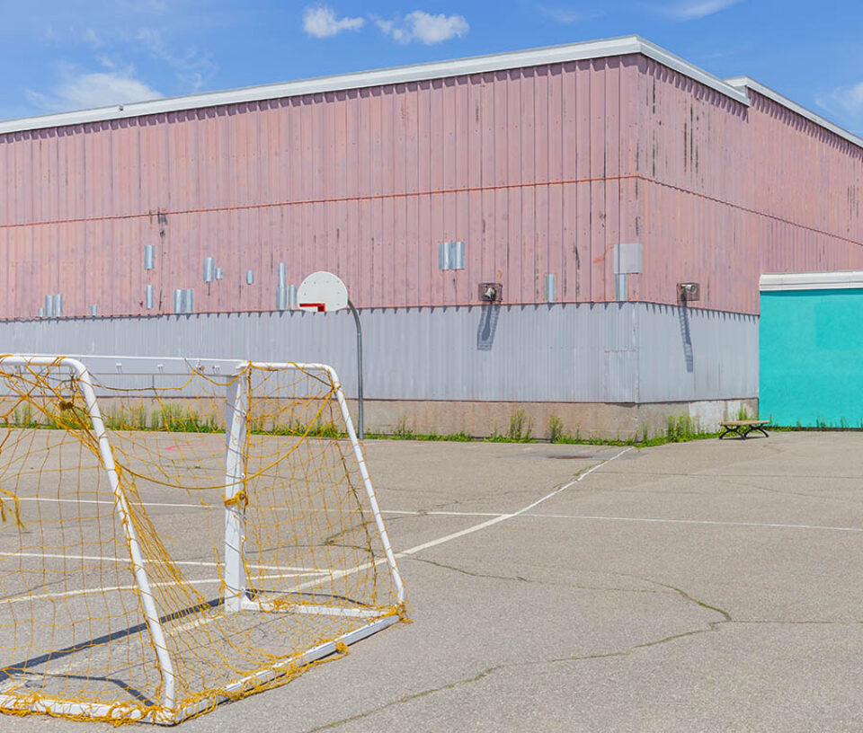 Goalposts and basketball net in playground