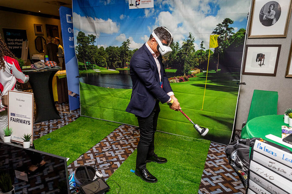 Event attendee playing virtual golf